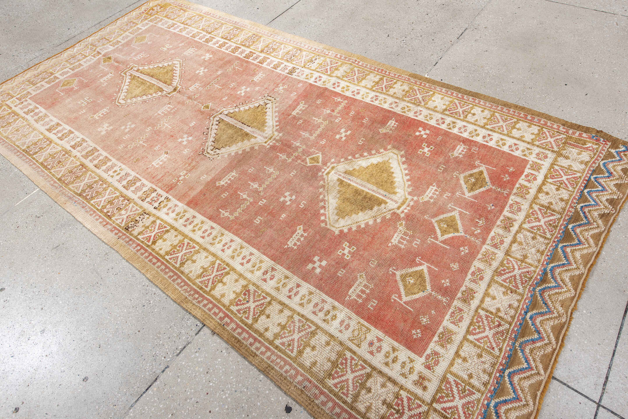 4' x 8' one-of-a-kind handmade antique Moroccan rug. Color palette: salmon, ivory, ochre, camel, rose, tan, blue, pink, gold
