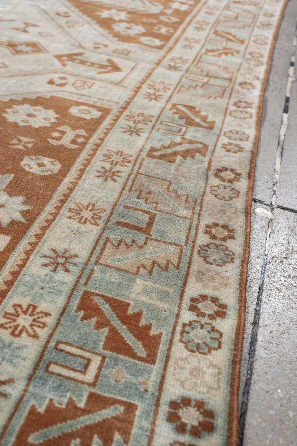 4' x 5' one-of-a-kind handmade antique Caucasian small size rug. Color palette: terra cotta, ivory, pale blue, camel, taupe