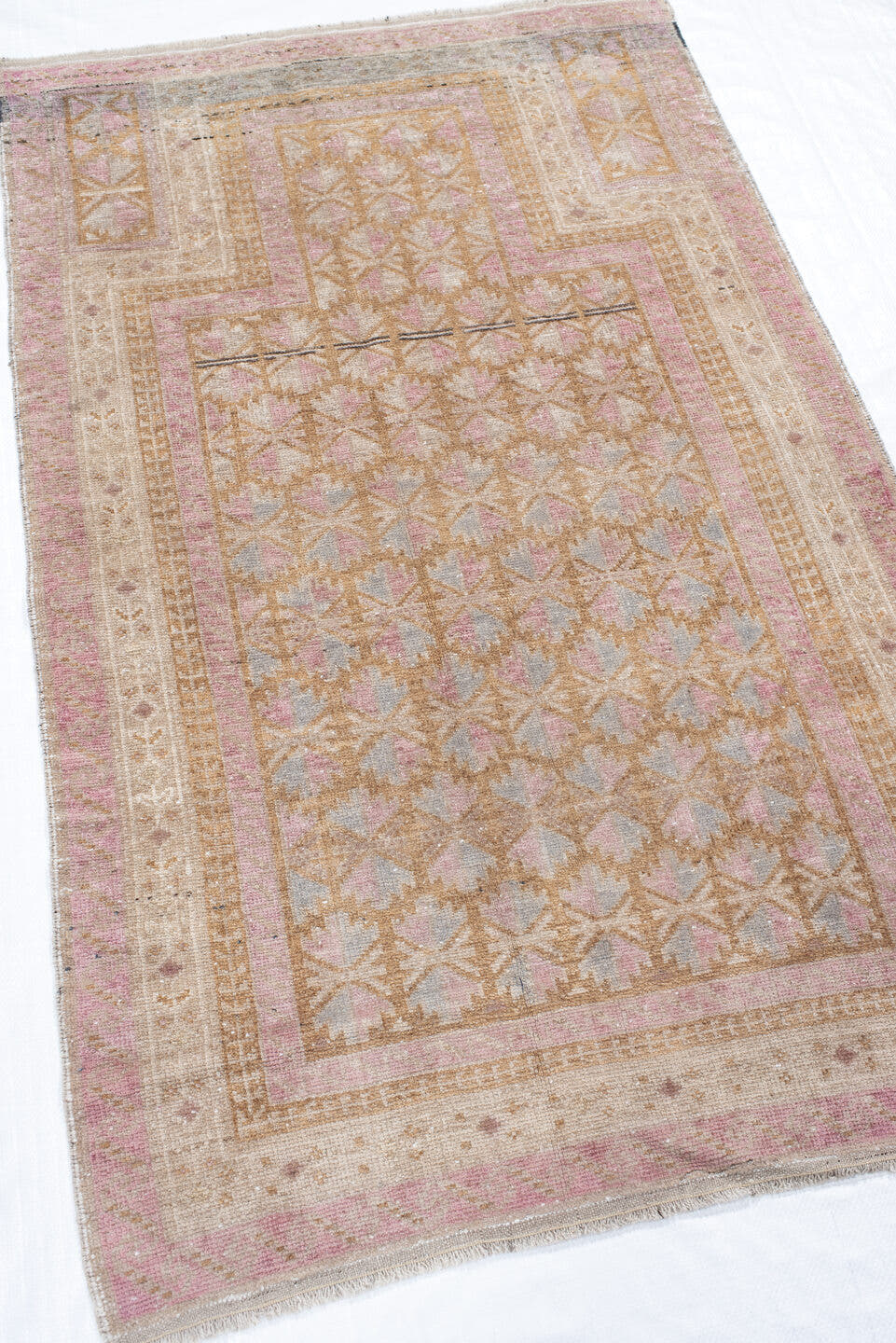 2' x 4' one-of-a-kind handmade vintage Belouch small size rug. Color palette: ivory, blush, camel, taupe, dusty rose