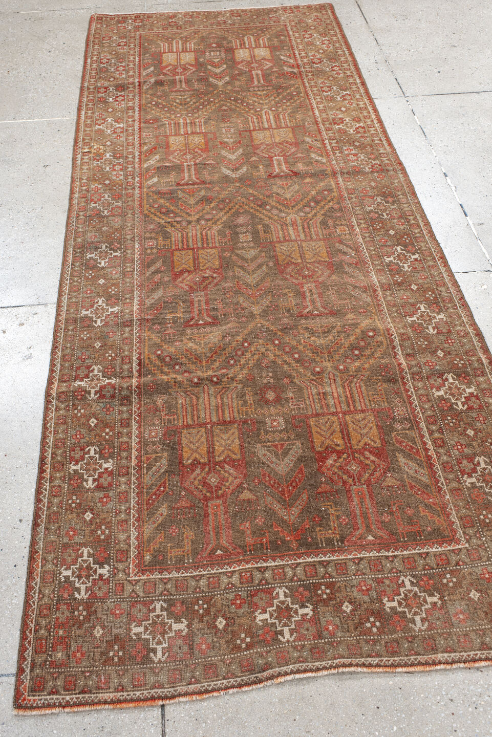 3' x 9' one-of-a-kind handmade vintage Belouch runner rug. Color palette: brown, gray, orange, pink, red