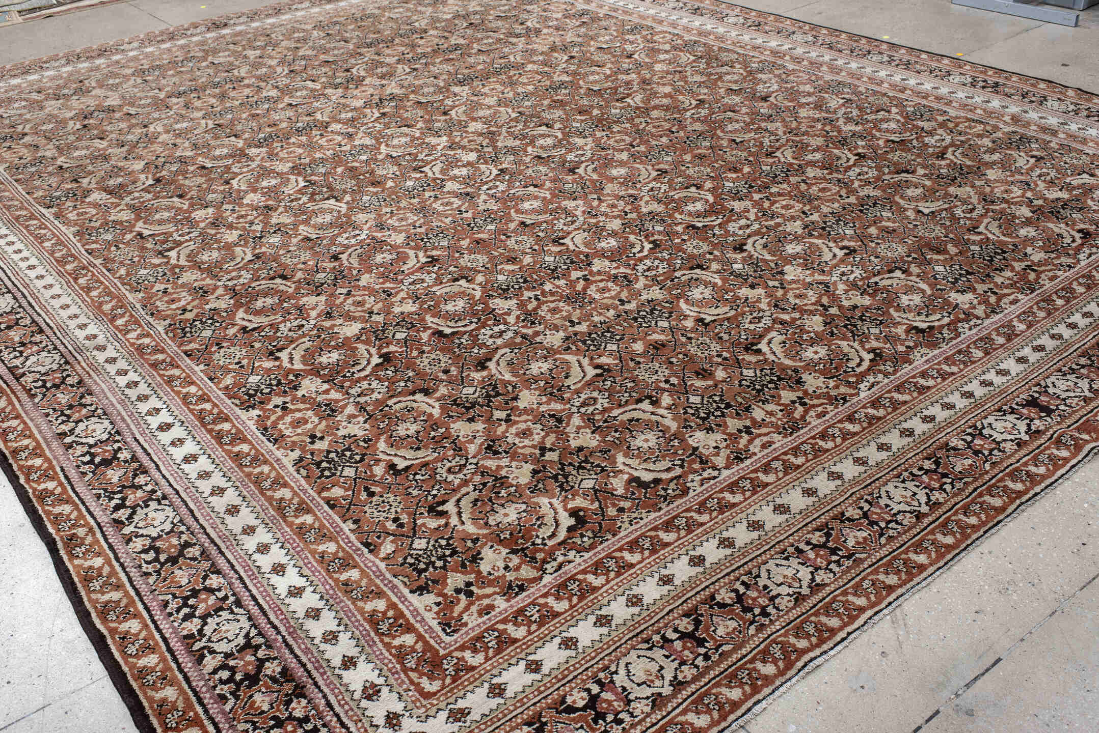 12' x 15' one-of-a-kind handmade antique Agra oversize rug. Color palette: terra cotta, ivory, charcoal, taupe, brown, camel