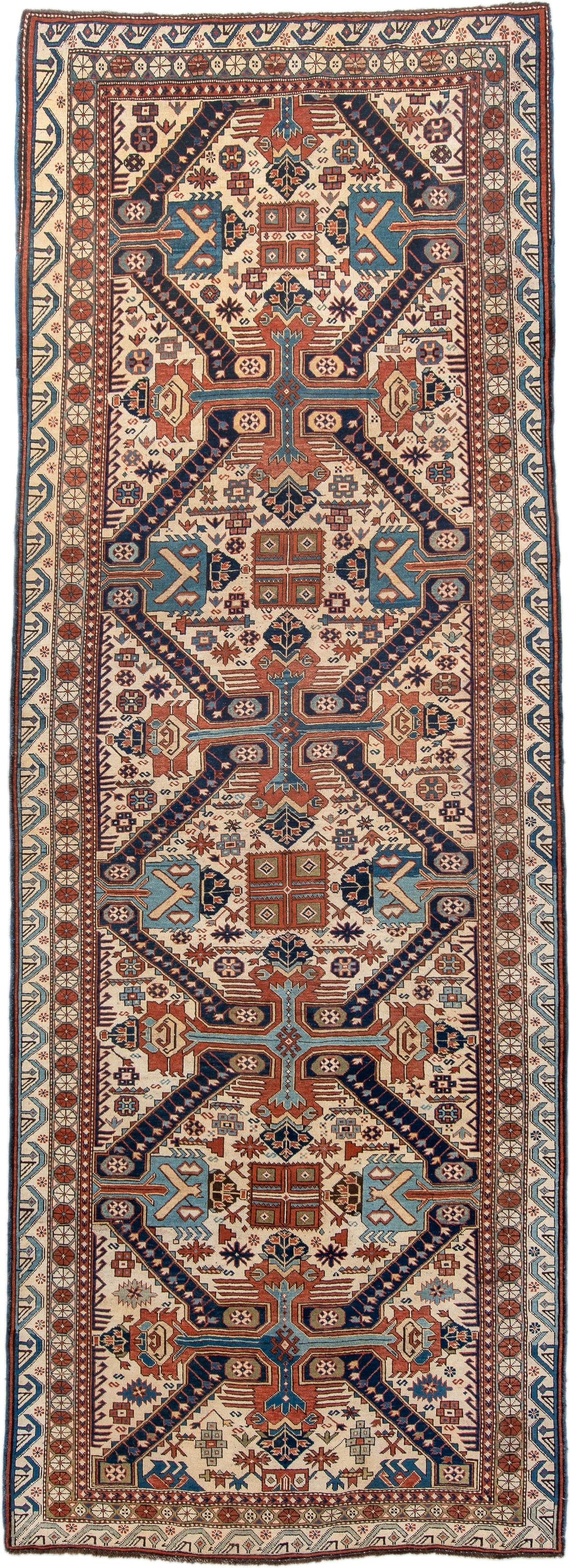 4' x 11' one-of-a-kind handmade antique Caucasian runner rug. Color palette: ivory, indigo, rust, sky blue, navy, camel