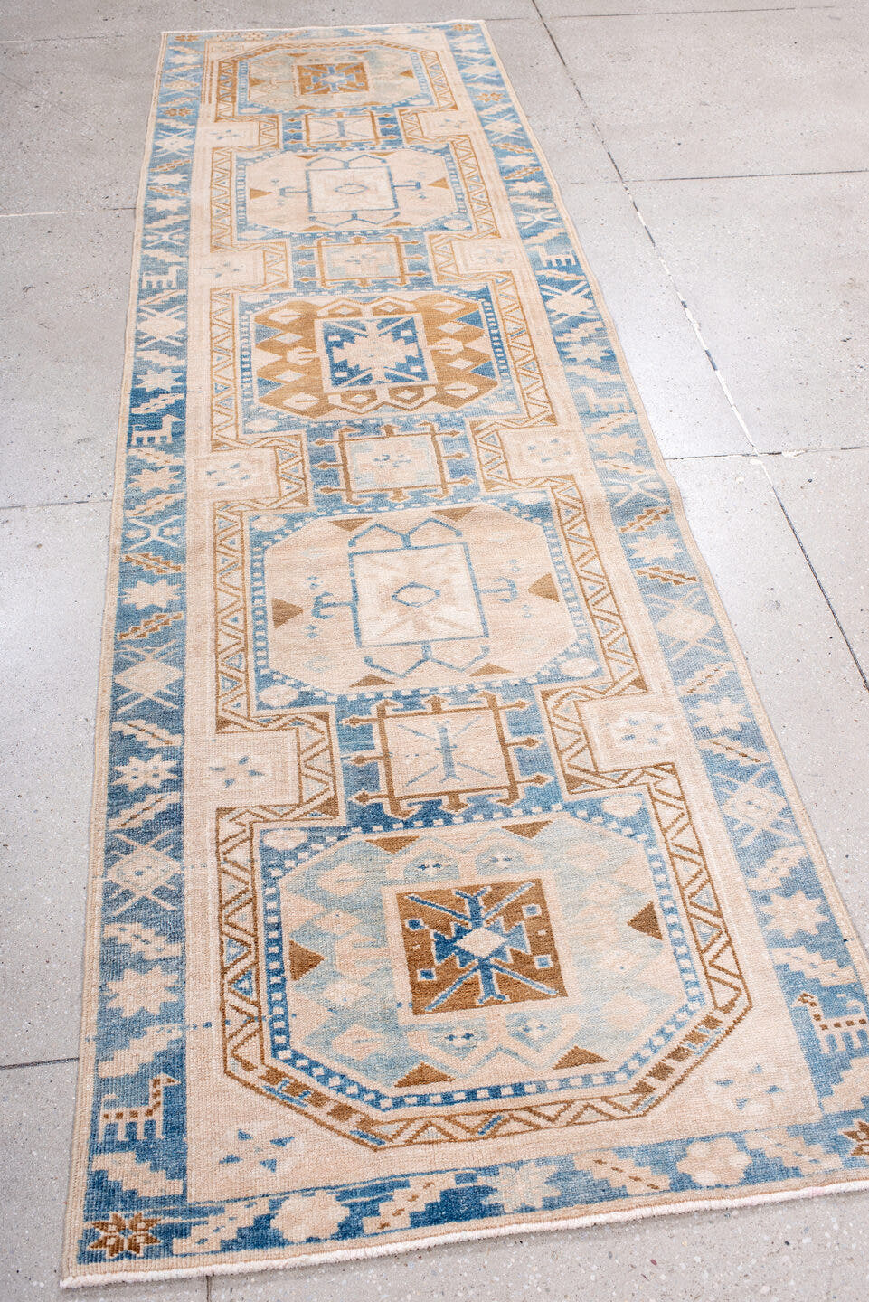 2' x 10' one-of-a-kind handmade antique Heriz runner rug. Color palette: ivory, sky blue, camel, light blue, taupe, brown