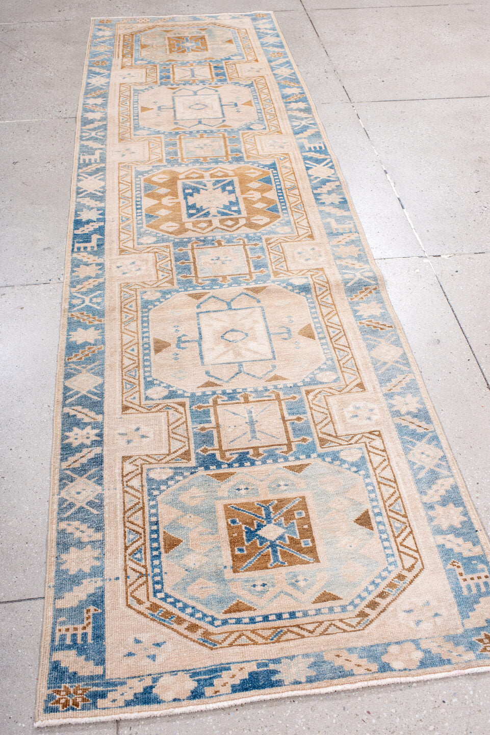 2' x 10' one-of-a-kind handmade antique Heriz runner rug. Color palette: ivory, sky blue, camel, light blue, taupe, brown