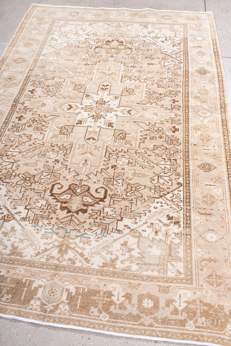 4' x 7' one-of-a-kind handmade antique Heriz rug. Color palette: ivory, blush, camel, taupe, beige, brown, pale blue, pink