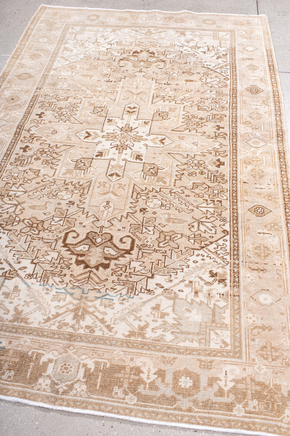 4' x 7' one-of-a-kind handmade antique Heriz rug. Color palette: ivory, blush, camel, taupe, beige, brown, pale blue, pink