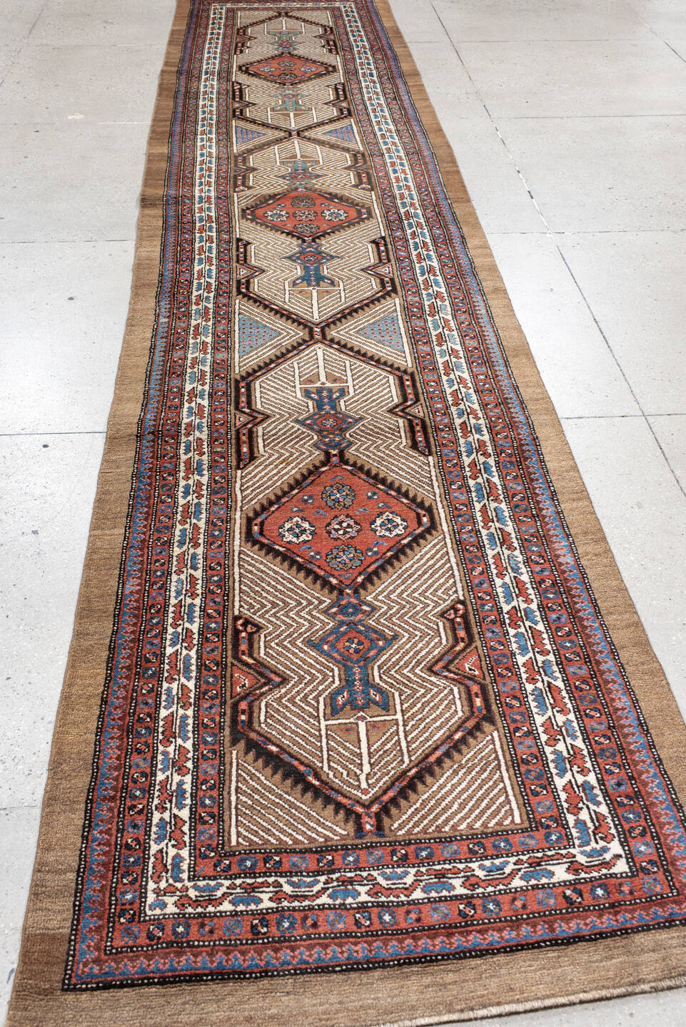 3' x 16' one-of-a-kind handmade antique Sarab runner rug. Color palette: ivory, rust, red, indigo, camel, navy, brown