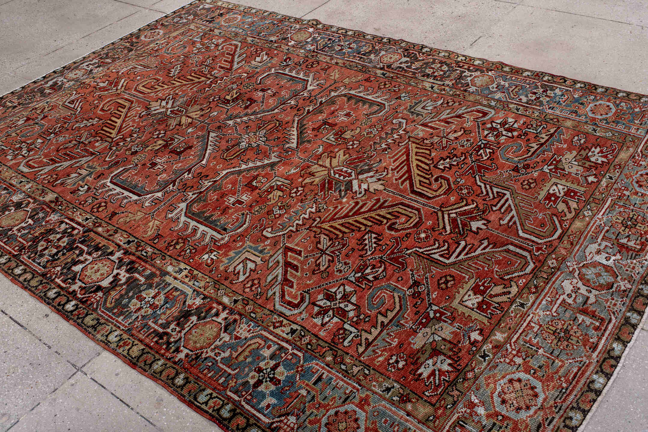 6' x 9' one-of-a-kind handmade antique Heriz rug. Color palette: terra cotta, rust, sky blue, ivory, charcoal, camel