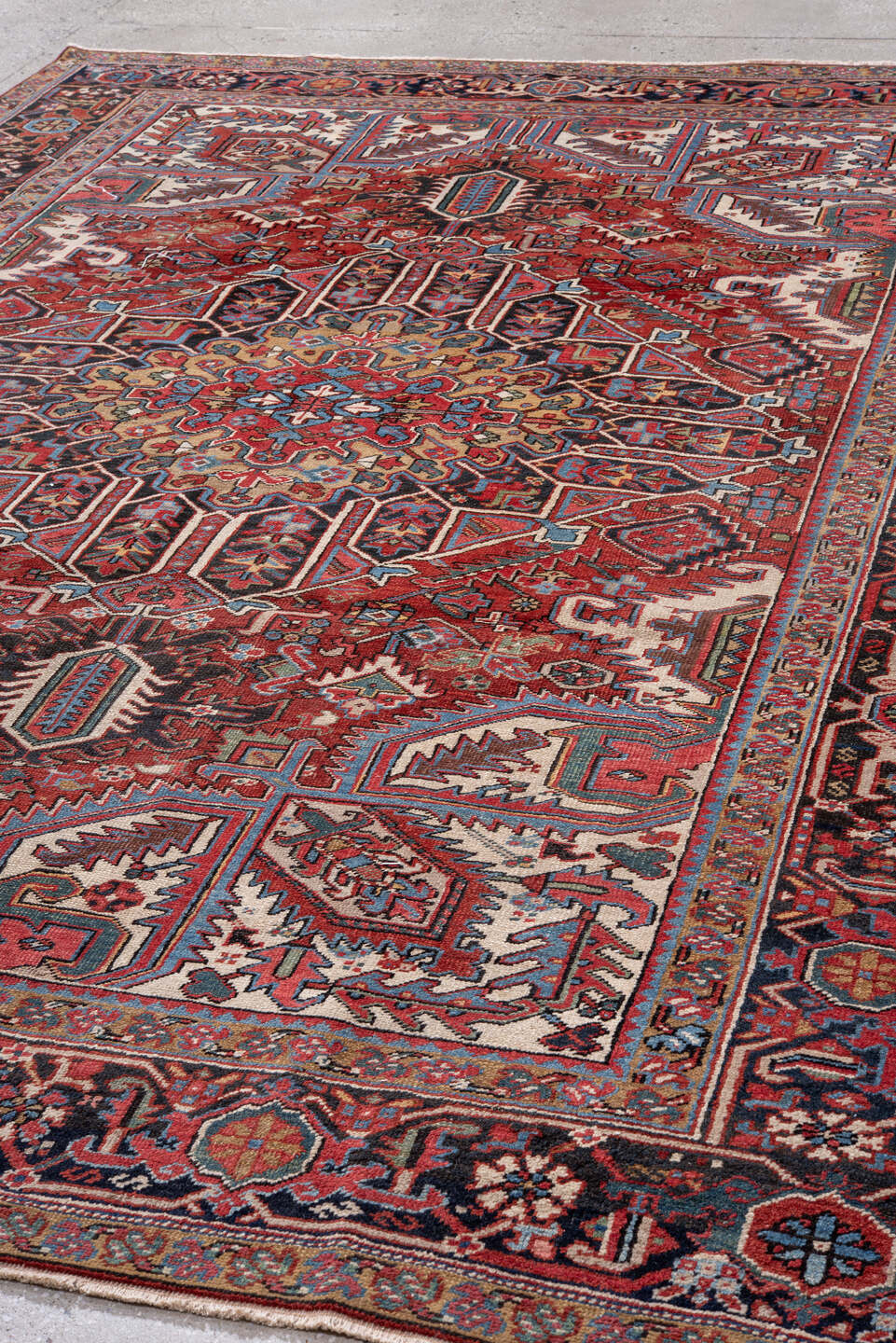 7' x 10' one-of-a-kind handmade vintage Heriz large size rug. Color palette: rust, navy, ivory, sky blue, camel, crimson