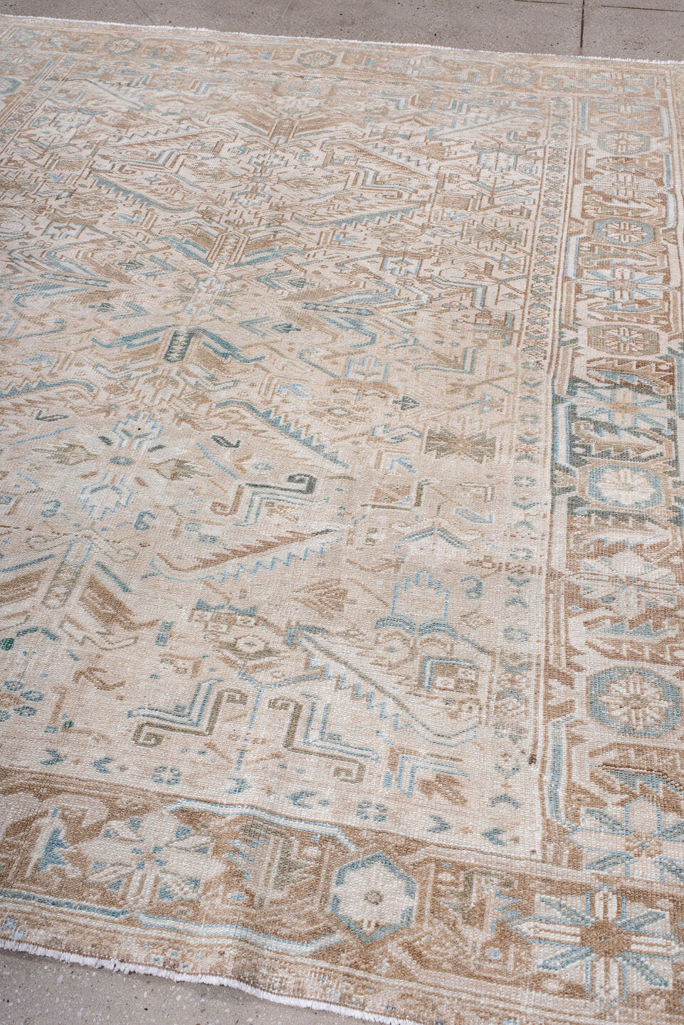 7' x 8' one-of-a-kind handmade antique Heriz rug. Color palette: ivory, camel, pale blue, taupe, beige, light brown