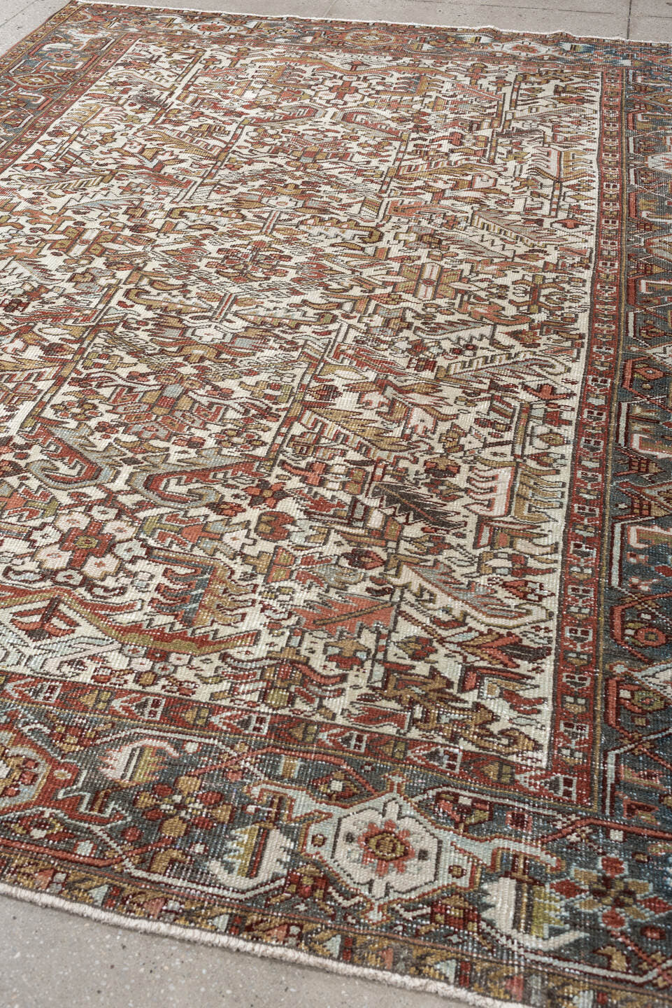 7' x 9' one-of-a-kind handmade vintage Heriz rug. Color palette: ivory, blue gray, rust, camel, sage, terracotta, taupe