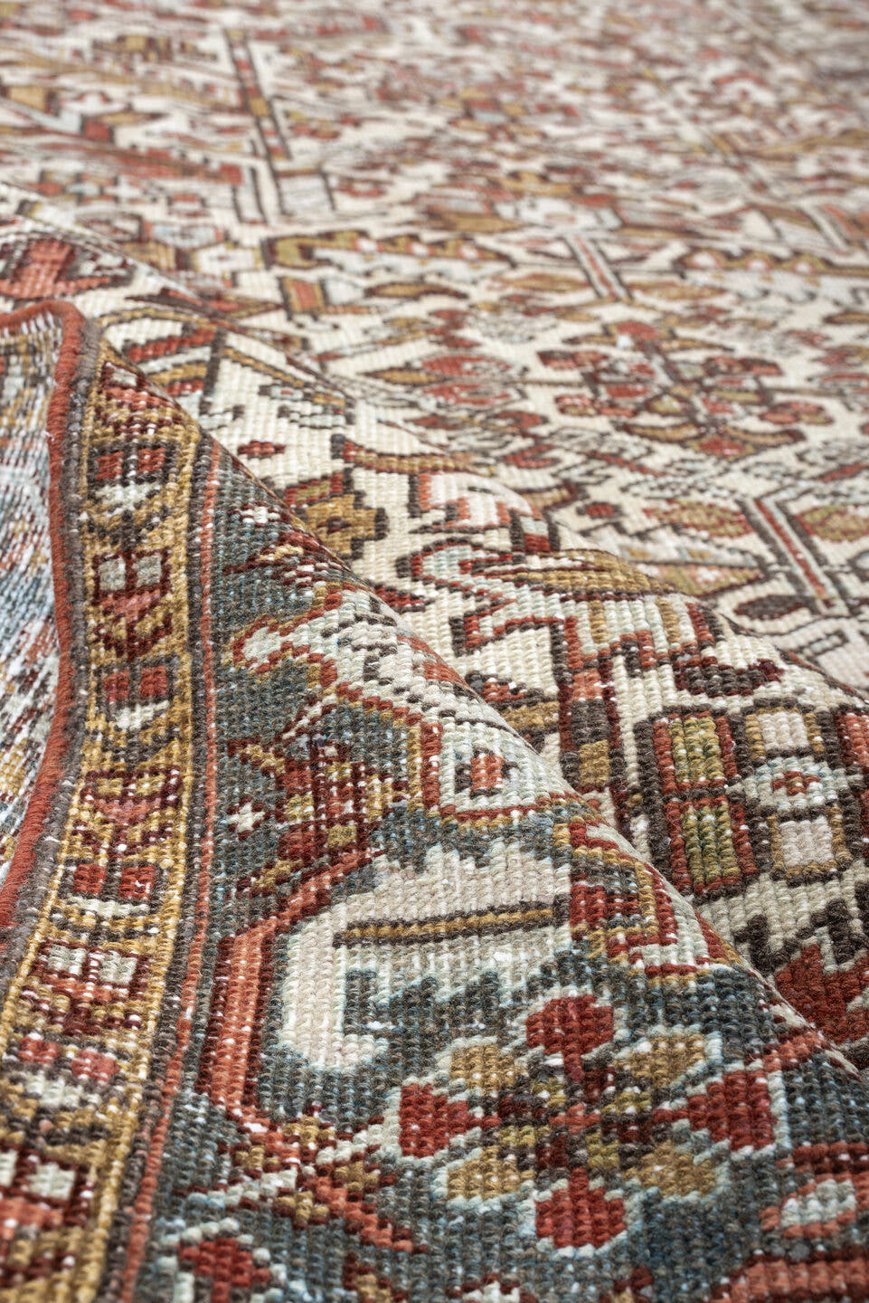 7' x 9' one-of-a-kind handmade vintage Heriz rug. Color palette: ivory, blue gray, rust, camel, sage, terracotta, taupe