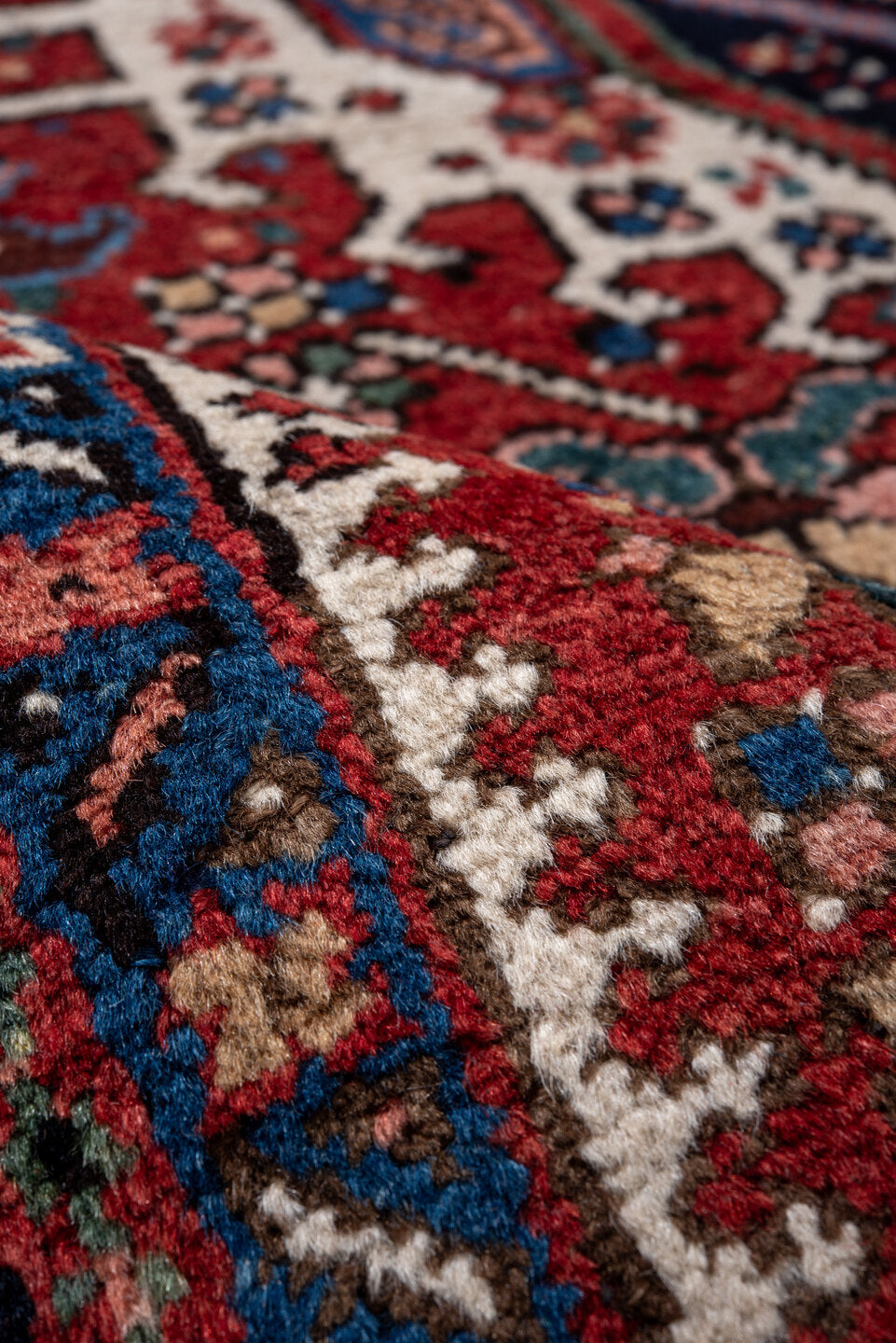 4' x 6' one-of-a-kind handmade vintage Karaje rug. Color palette: red, navy, ivory, sky blue, teal, rose, coral, charcoal
