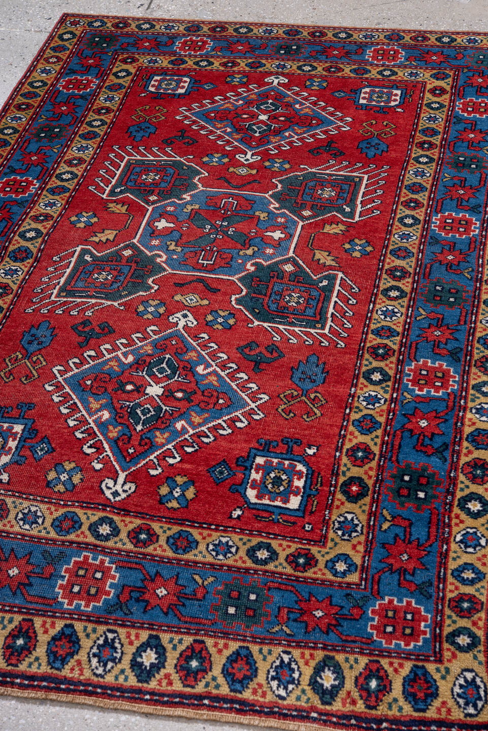3' x 5' one-of-a-kind handmade vintage Caucasian small size rug. Color palette: red, blue, ivory, navy, teal, gold, crimson