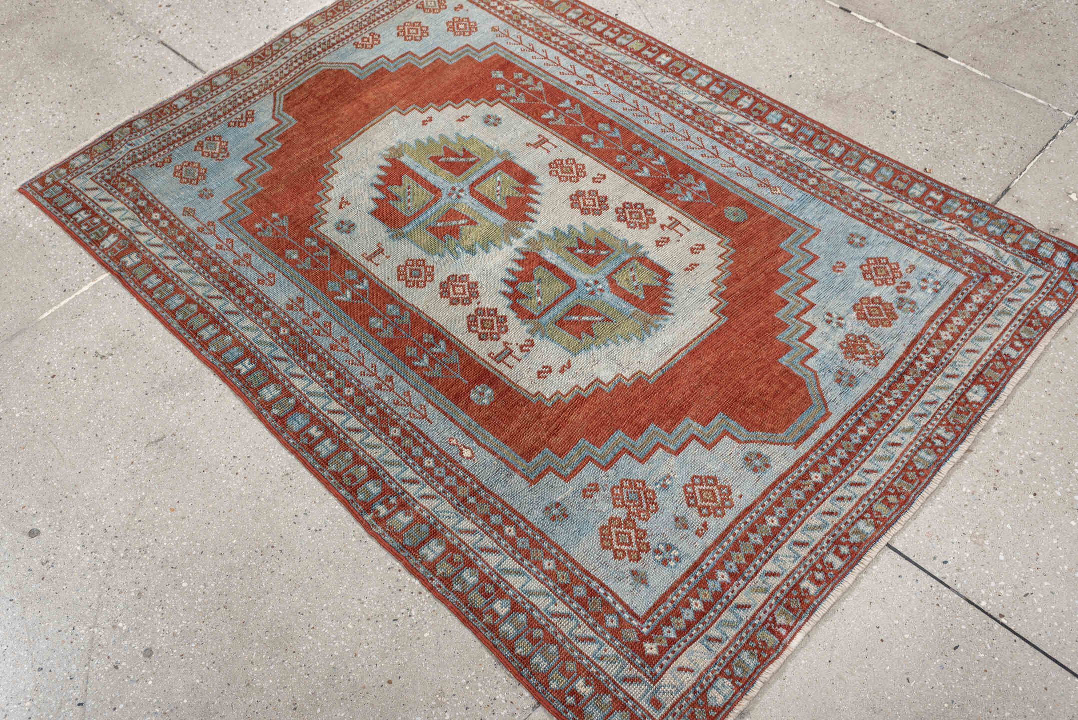 4' x 3' one-of-a-kind handmade antique Caucasian rug. Color palette: terracotta, sky blue, ivory, sage, rust, brown