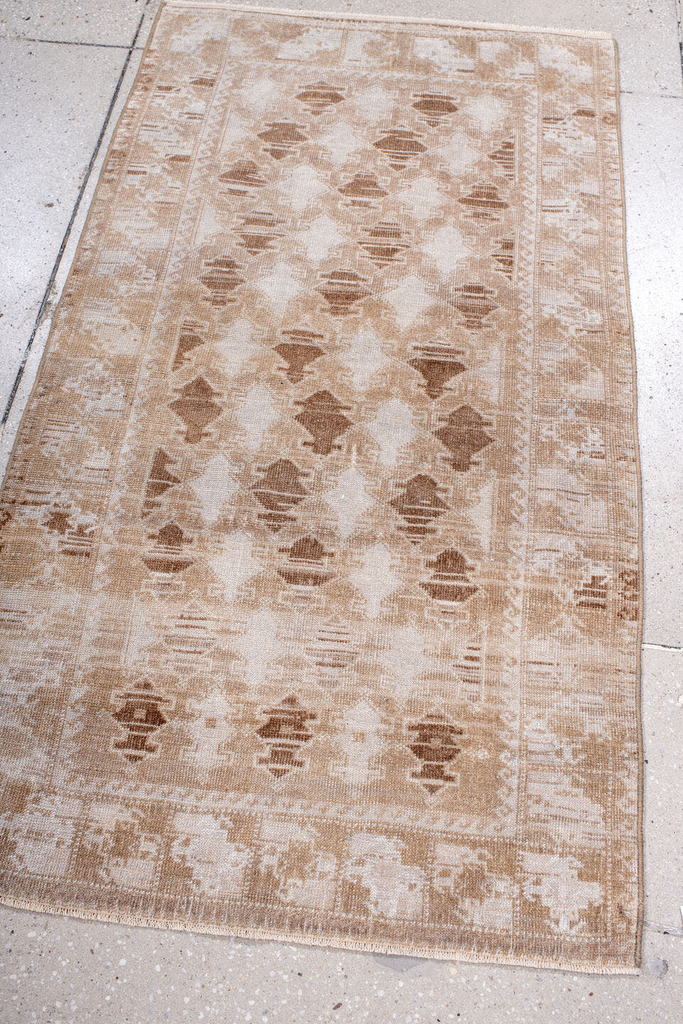 2' x 4' one-of-a-kind handmade antique Belouch small size rug. Color palette: ivory, camel, taupe, beige, gray