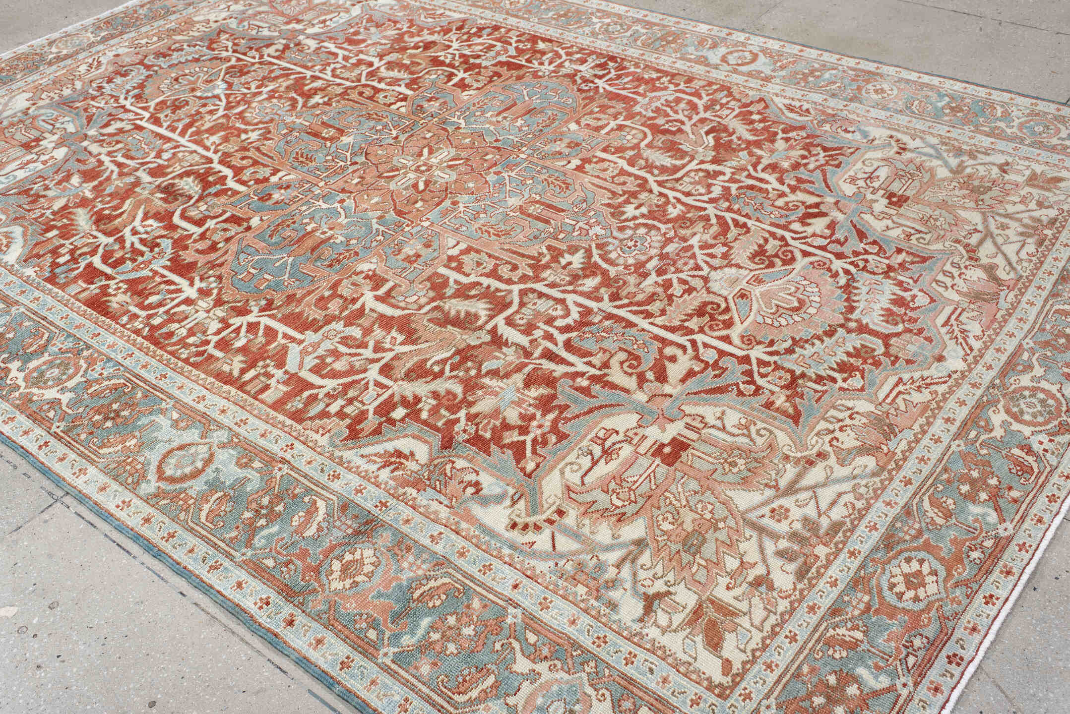7' x 10' one-of-a-kind handmade antique Heriz large size rug. Color palette: rust, ivory, pale blue, terra cotta, sage
