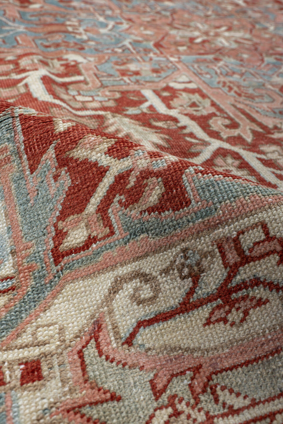 7' x 10' one-of-a-kind handmade antique Heriz large size rug. Color palette: rust, ivory, pale blue, terra cotta, sage