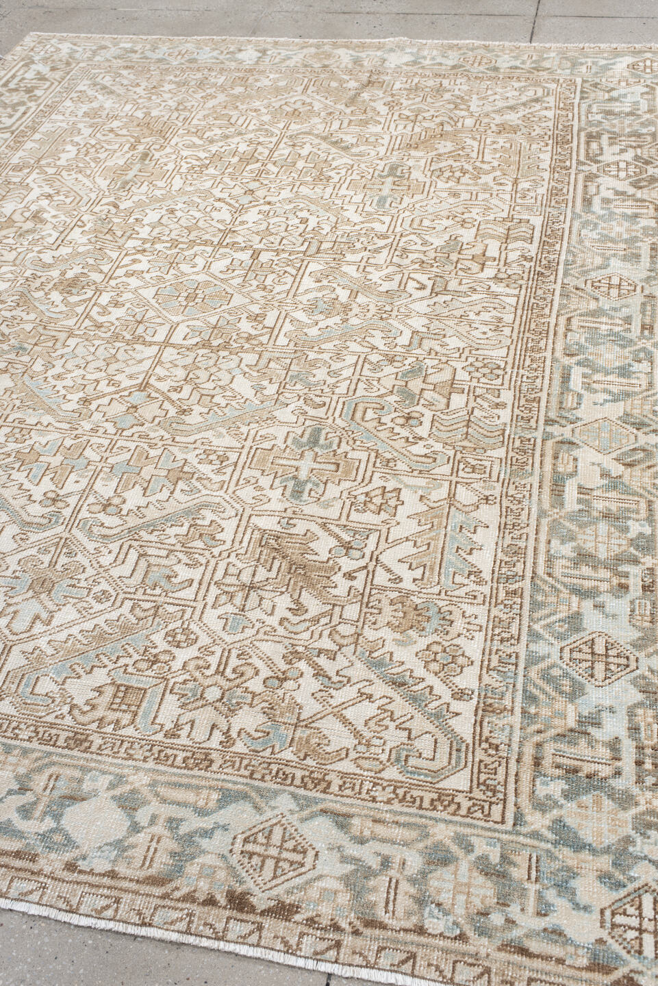 7' x 9' one-of-a-kind handmade antique Heriz rug. Color palette: ivory, camel, pale blue, taupe, beige, light gray