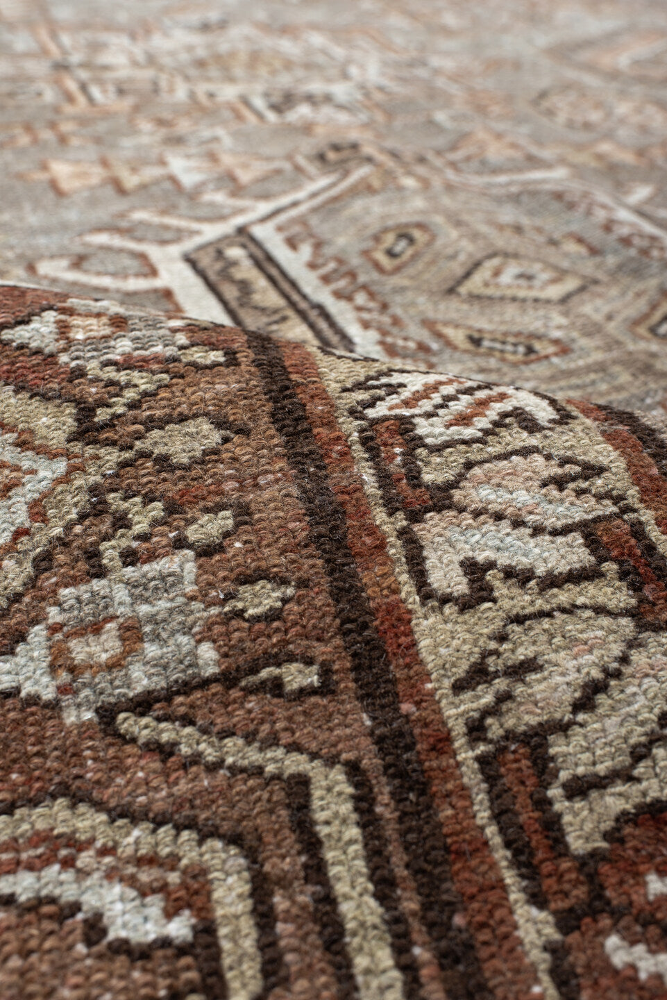 7' x 10' one-of-a-kind handmade vintage Karaje large size rug. Color palette: taupe, brown, ivory, camel, slate, rust, beige