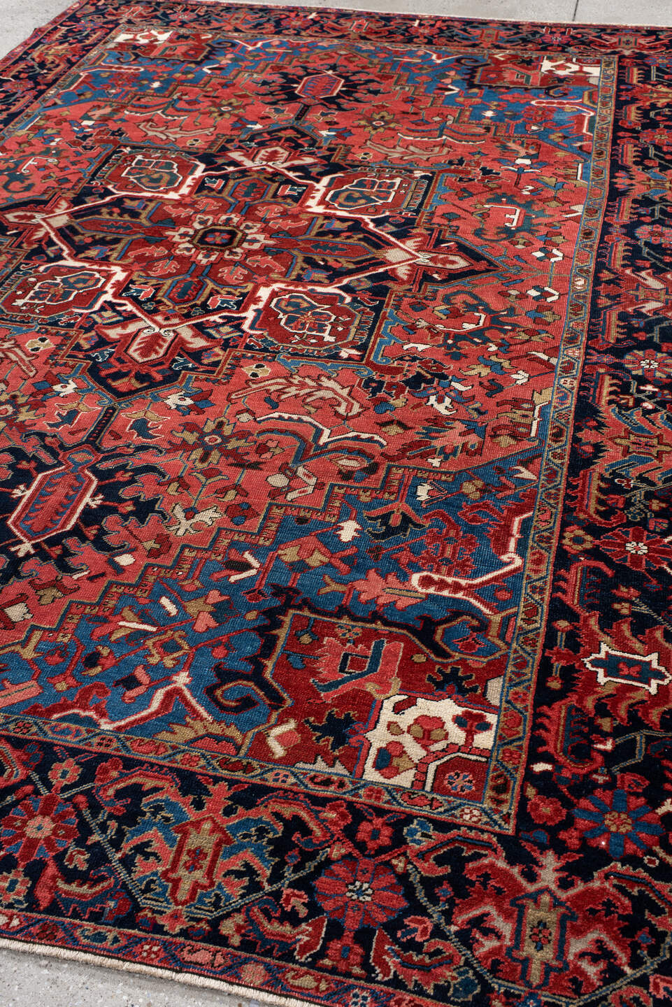 7' x 11' one-of-a-kind handmade antique Heriz large size rug. Color palette: rust, navy, sky_blue, ivory, brick, coral