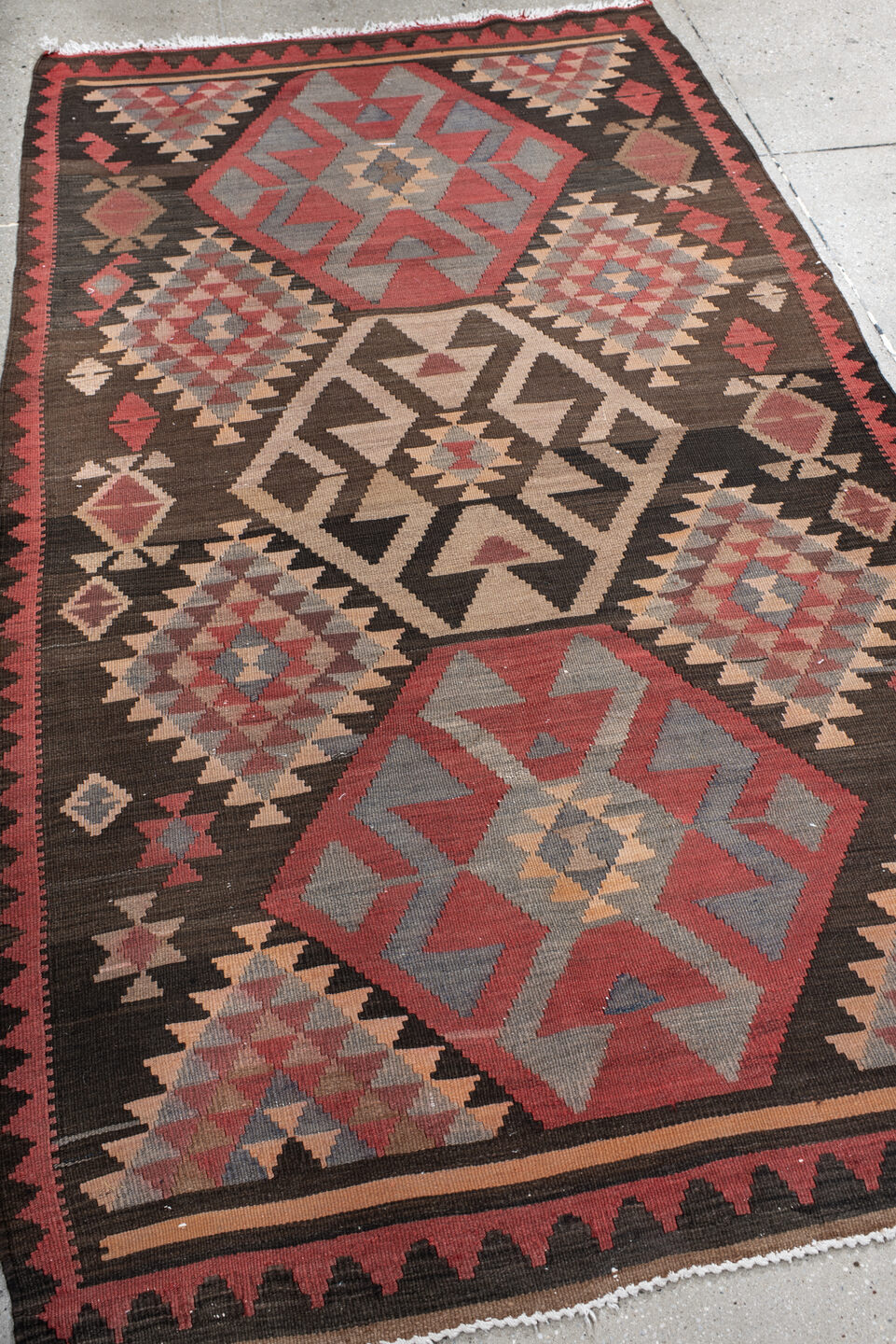 4' x 7' one-of-a-kind handmade vintage Kilim rug. Color palette: black, brown, dim gray, gray, light gray, off-white, orange