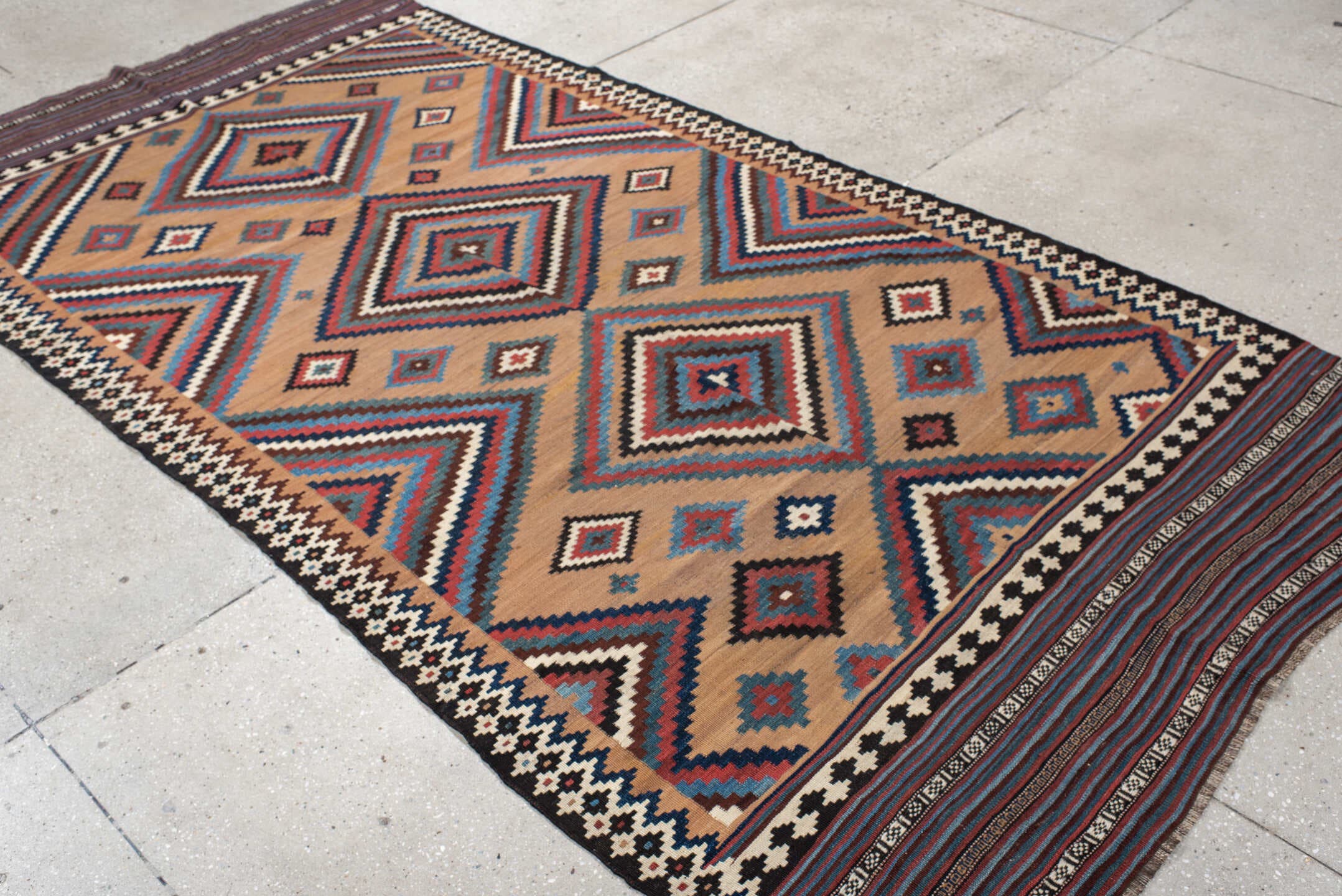 5' x 10' one-of-a-kind handmade antique Kilim runner rug. Color palette: camel, indigo, ivory, rust, turquoise, charcoal