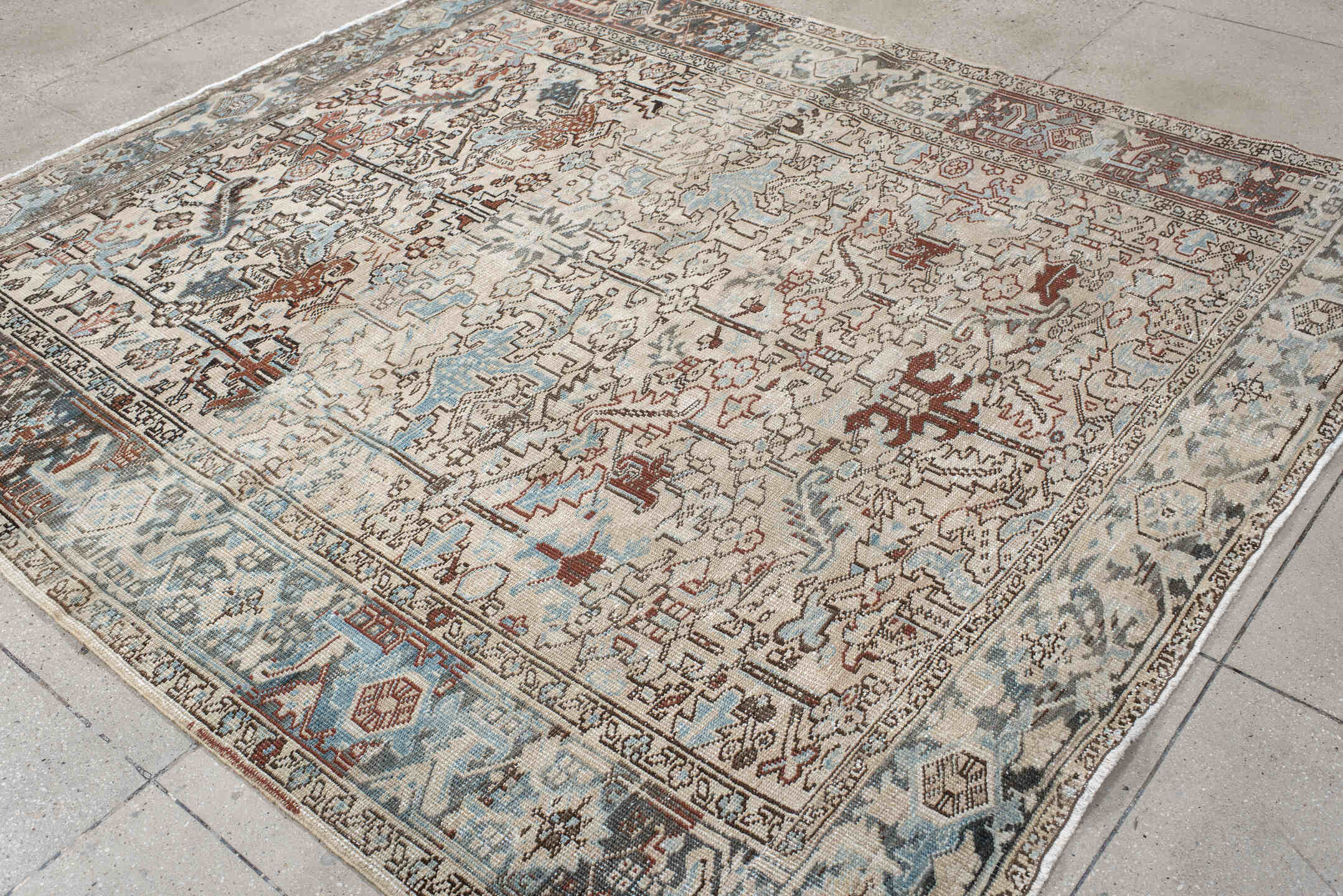 7' x 8' one-of-a-kind handmade antique Heriz rug. Color palette: ivory, sky blue, slate, taupe, rust, charcoal, camel