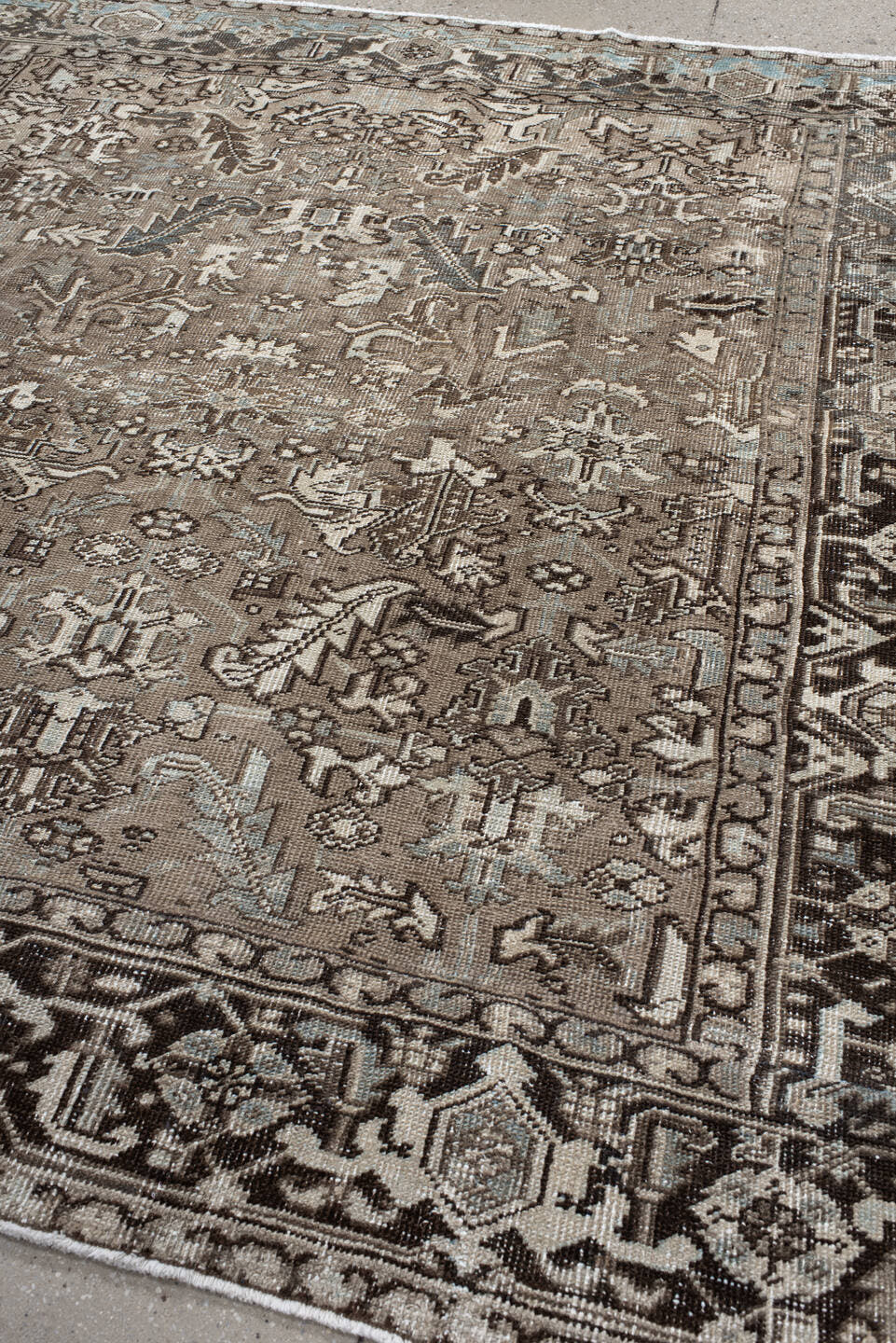 7' x 7' one-of-a-kind handmade antique Heriz rug. Color palette: taupe, ivory, charcoal, brown, slate, pale blue, beige
