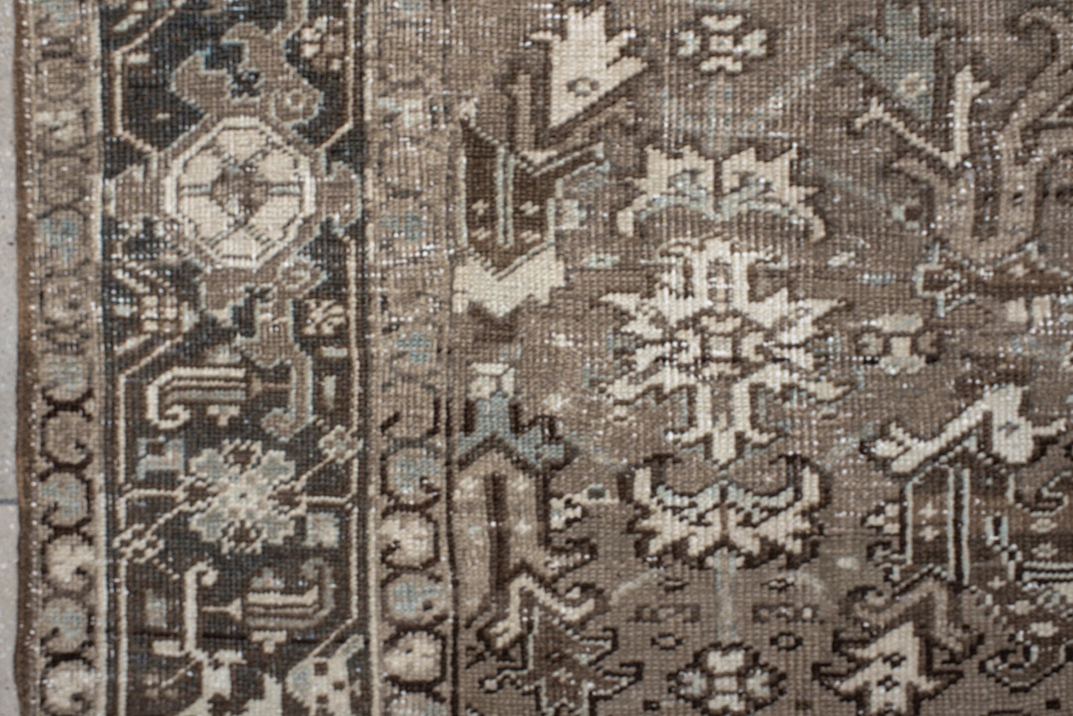7' x 7' one-of-a-kind handmade antique Heriz rug. Color palette: taupe, ivory, charcoal, brown, slate, pale blue, beige