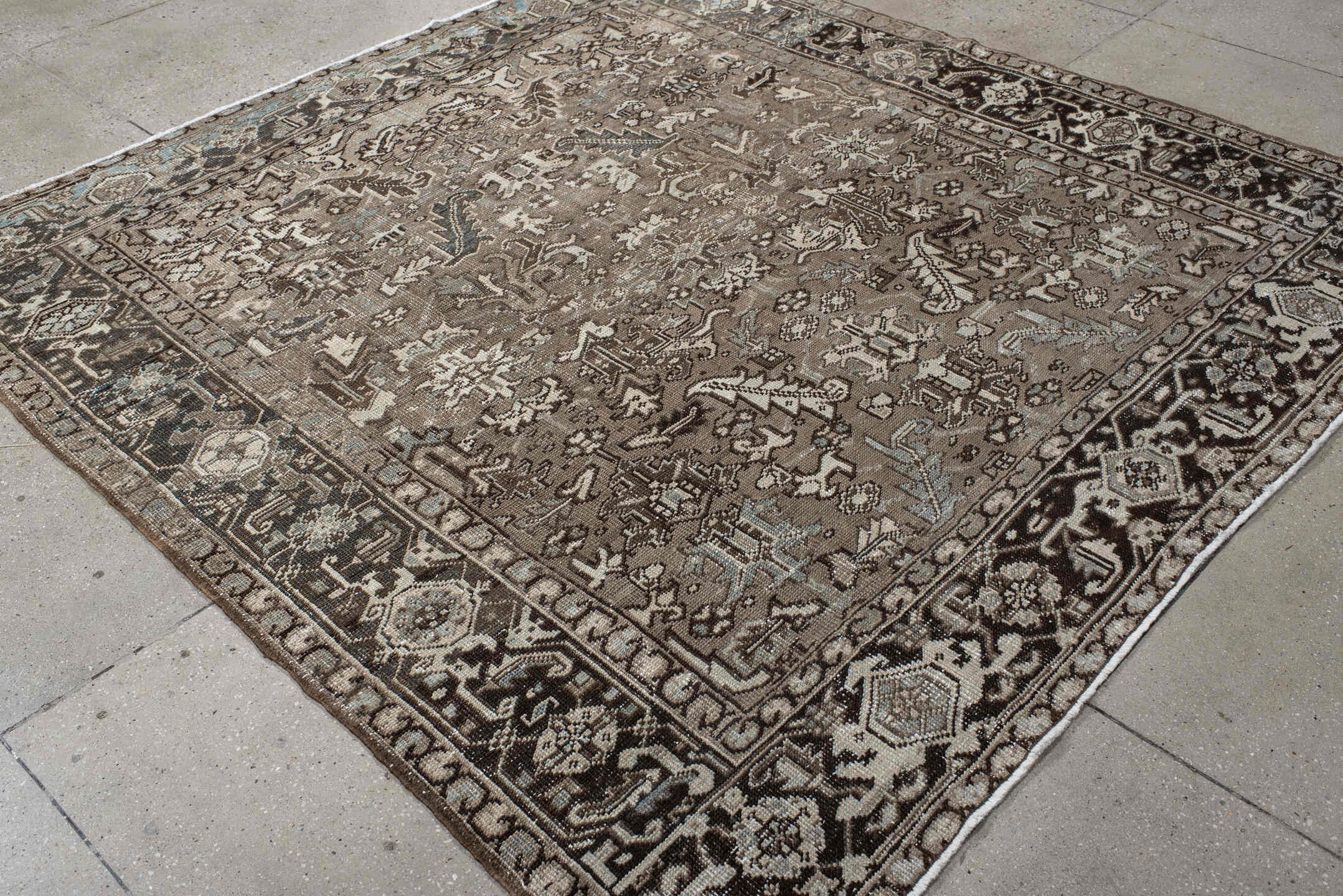 7' x 7' one-of-a-kind handmade antique Heriz rug. Color palette: taupe, ivory, charcoal, brown, slate, pale blue, beige