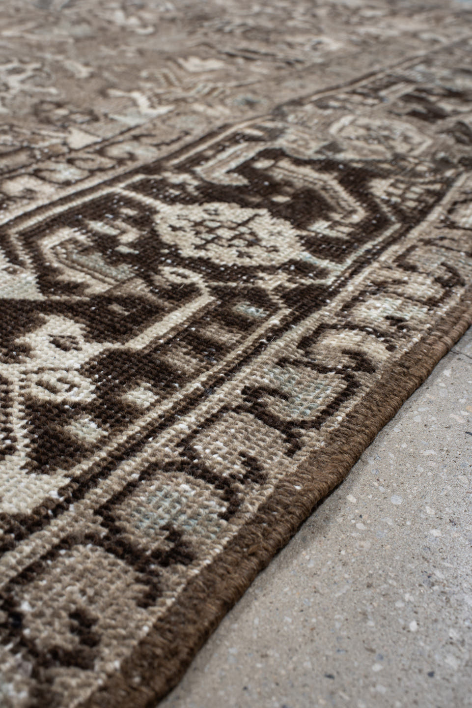 7' x 7' one-of-a-kind handmade antique Heriz rug. Color palette: taupe, ivory, charcoal, brown, slate, pale blue, beige