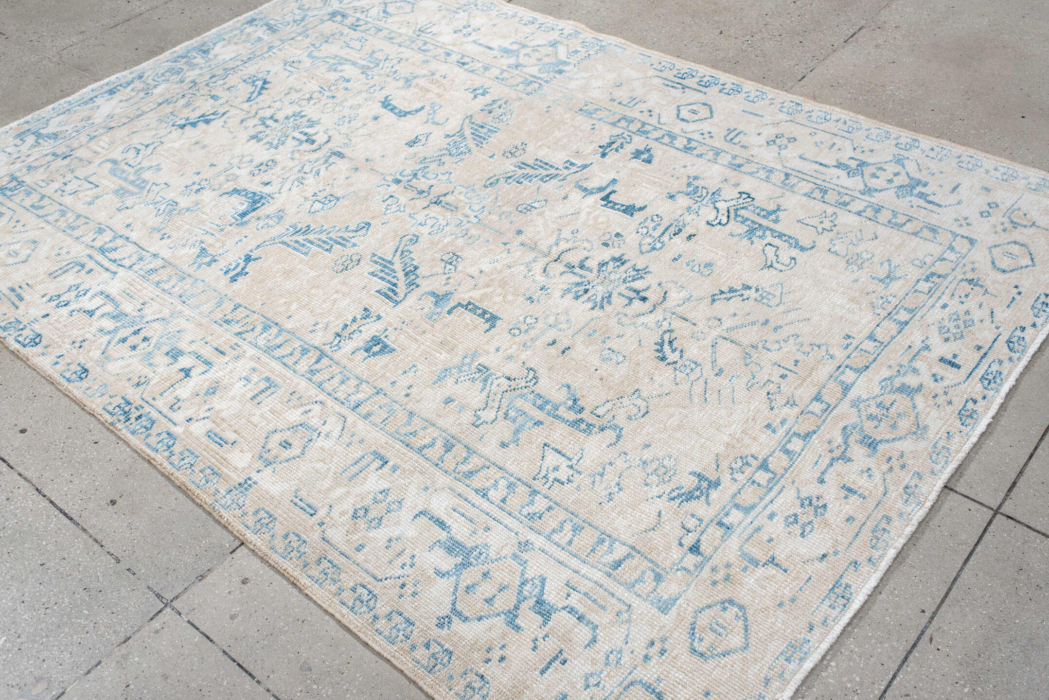 5' x 8' one-of-a-kind handmade antique Heriz medium size rug. Color palette: ivory, sky blue, ice blue, cream, beige
