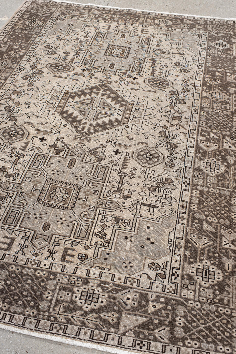 5' x 6' one-of-a-kind handmade vintage Karaje rug. Color palette: black, brown, gray, light gray, off-white, pink