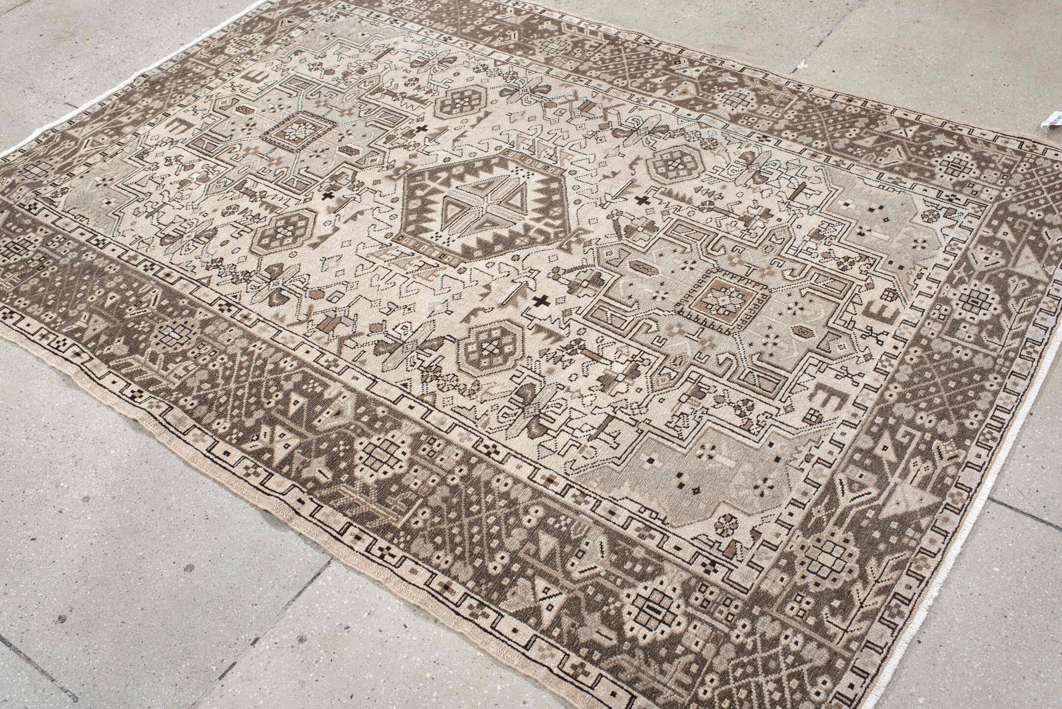 5' x 6' one-of-a-kind handmade vintage Karaje rug. Color palette: black, brown, gray, light gray, off-white, pink