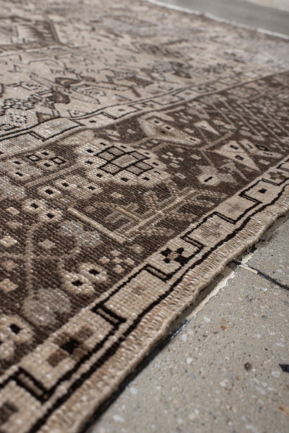 5' x 6' one-of-a-kind handmade vintage Karaje rug. Color palette: black, brown, gray, light gray, off-white, pink