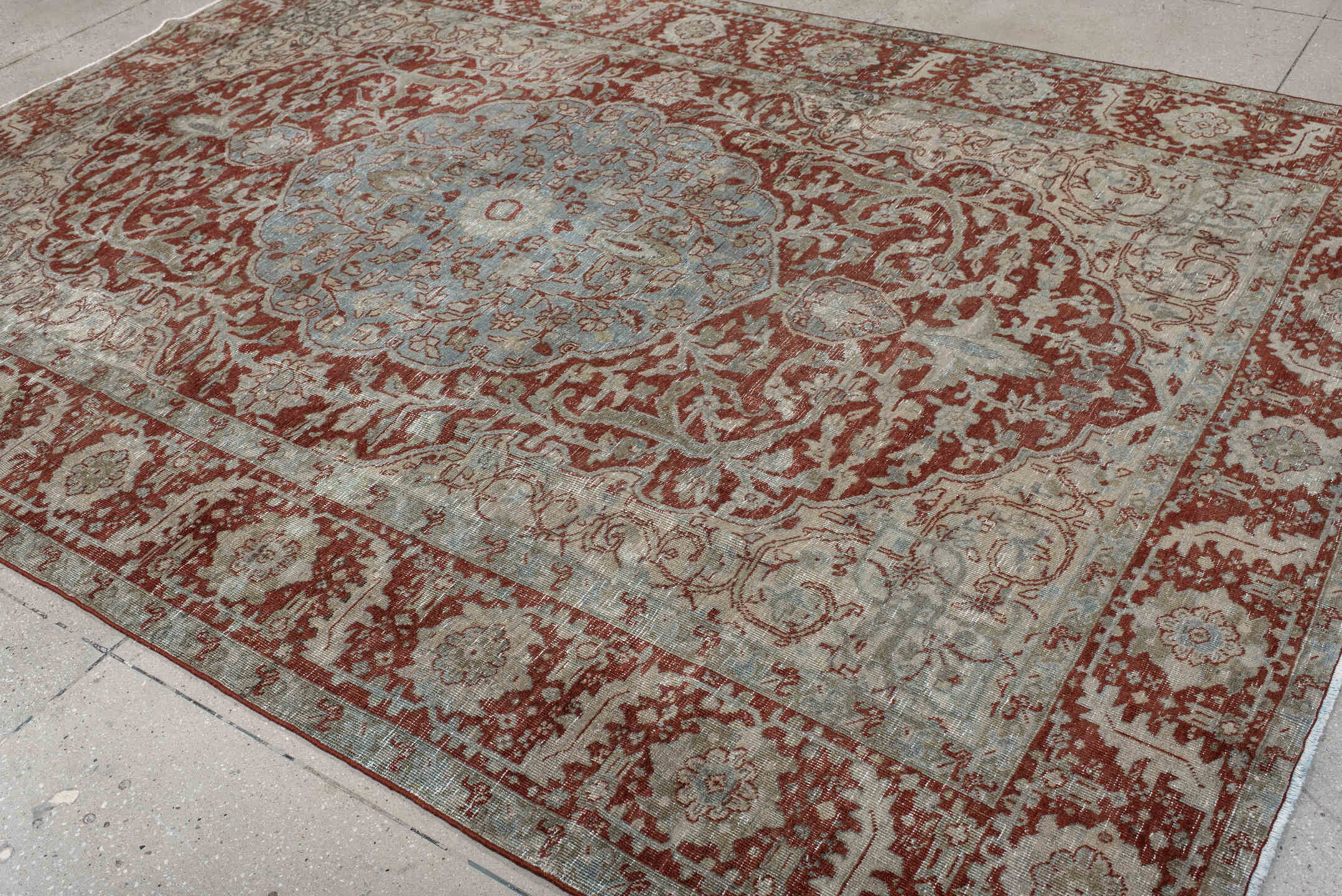 7' x 10' one-of-a-kind handmade antique Heriz large size rug. Color palette: rust, pale blue, ivory, brick, sage, taupe