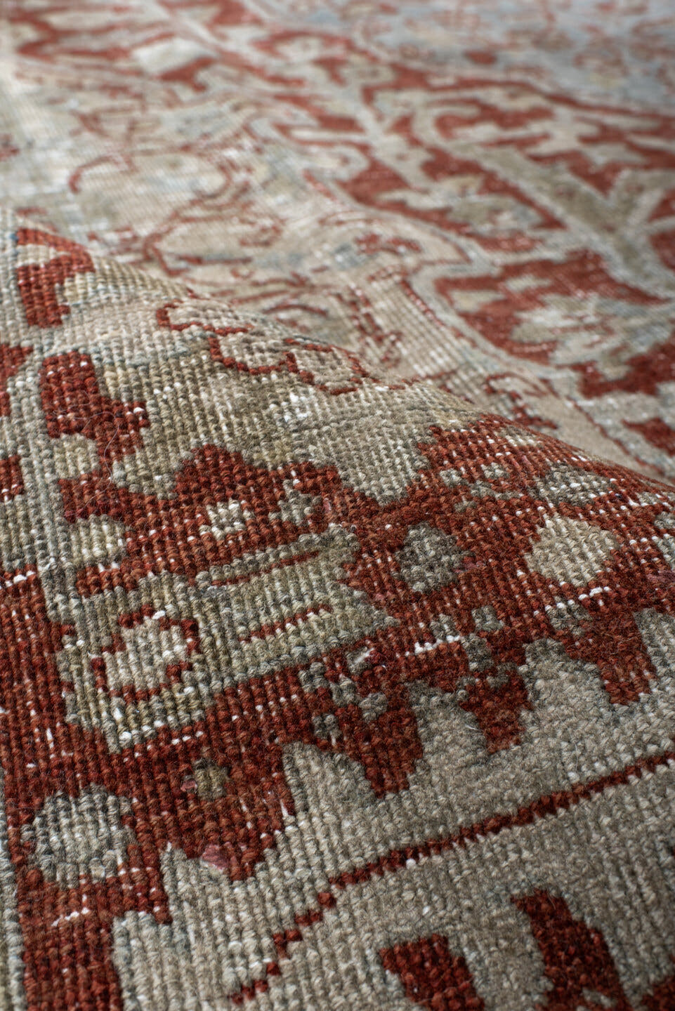 7' x 10' one-of-a-kind handmade antique Heriz large size rug. Color palette: rust, pale blue, ivory, brick, sage, taupe