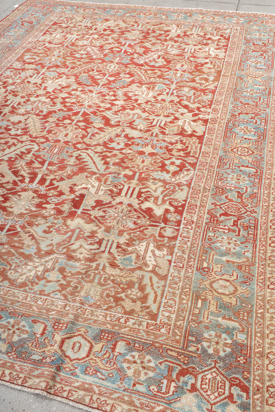 7' x 10' one-of-a-kind handmade antique Heriz large size rug. Color palette: rust, ivory, sky blue, coral, brick, cream