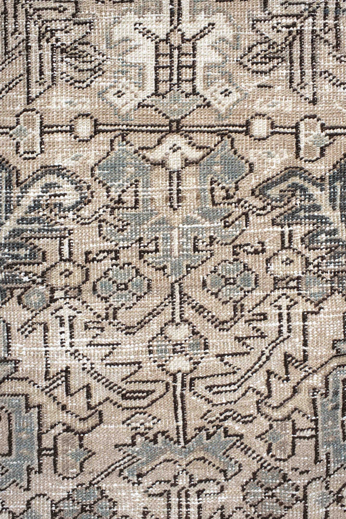 7' x 9' one-of-a-kind handmade antique Heriz rug. Color palette: ivory, taupe, slate, charcoal, camel, pale blue, brown