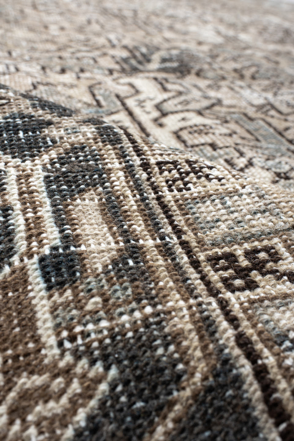 7' x 9' one-of-a-kind handmade antique Heriz rug. Color palette: ivory, taupe, slate, charcoal, camel, pale blue, brown