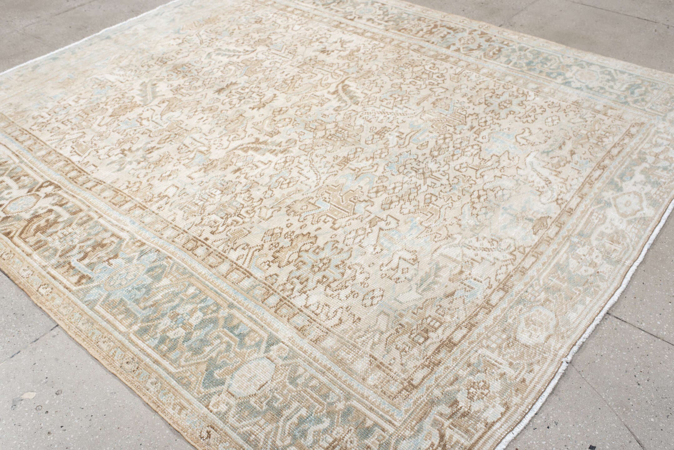 7' x 8' one-of-a-kind handmade antique Heriz rug. Color palette: ivory, taupe, pale blue, sand, beige, camel, gray