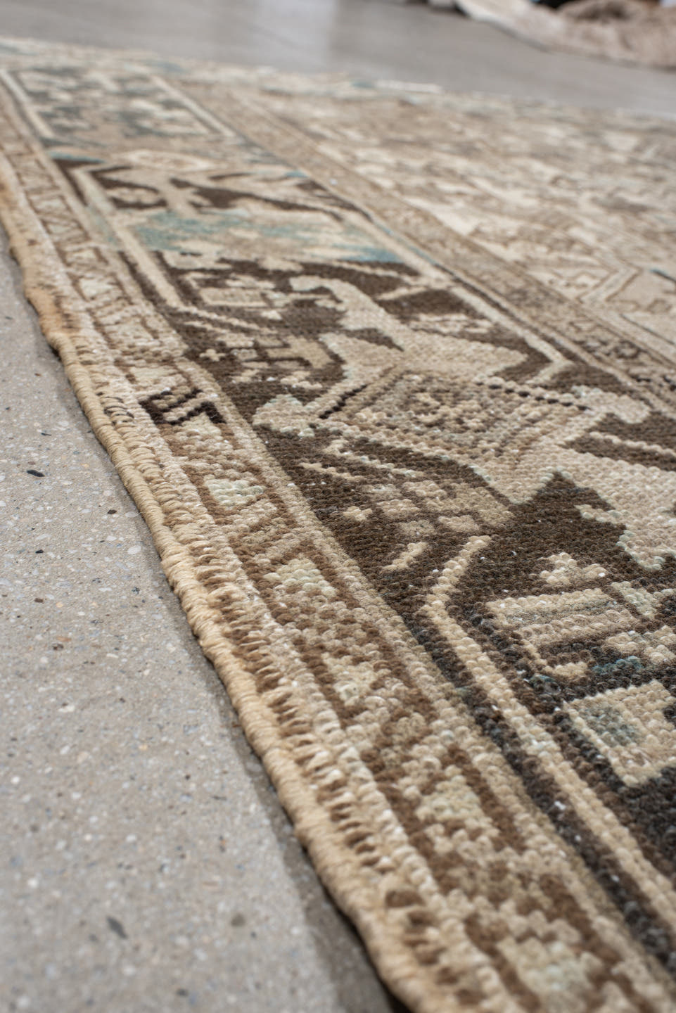 7' x 9' one-of-a-kind handmade antique Heriz rug. Color palette: ivory, taupe, charcoal, beige, sky blue, brown, gray, black