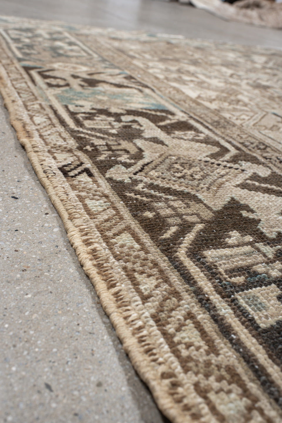 7' x 9' one-of-a-kind handmade antique Heriz rug. Color palette: ivory, taupe, charcoal, beige, sky blue, brown, gray, black