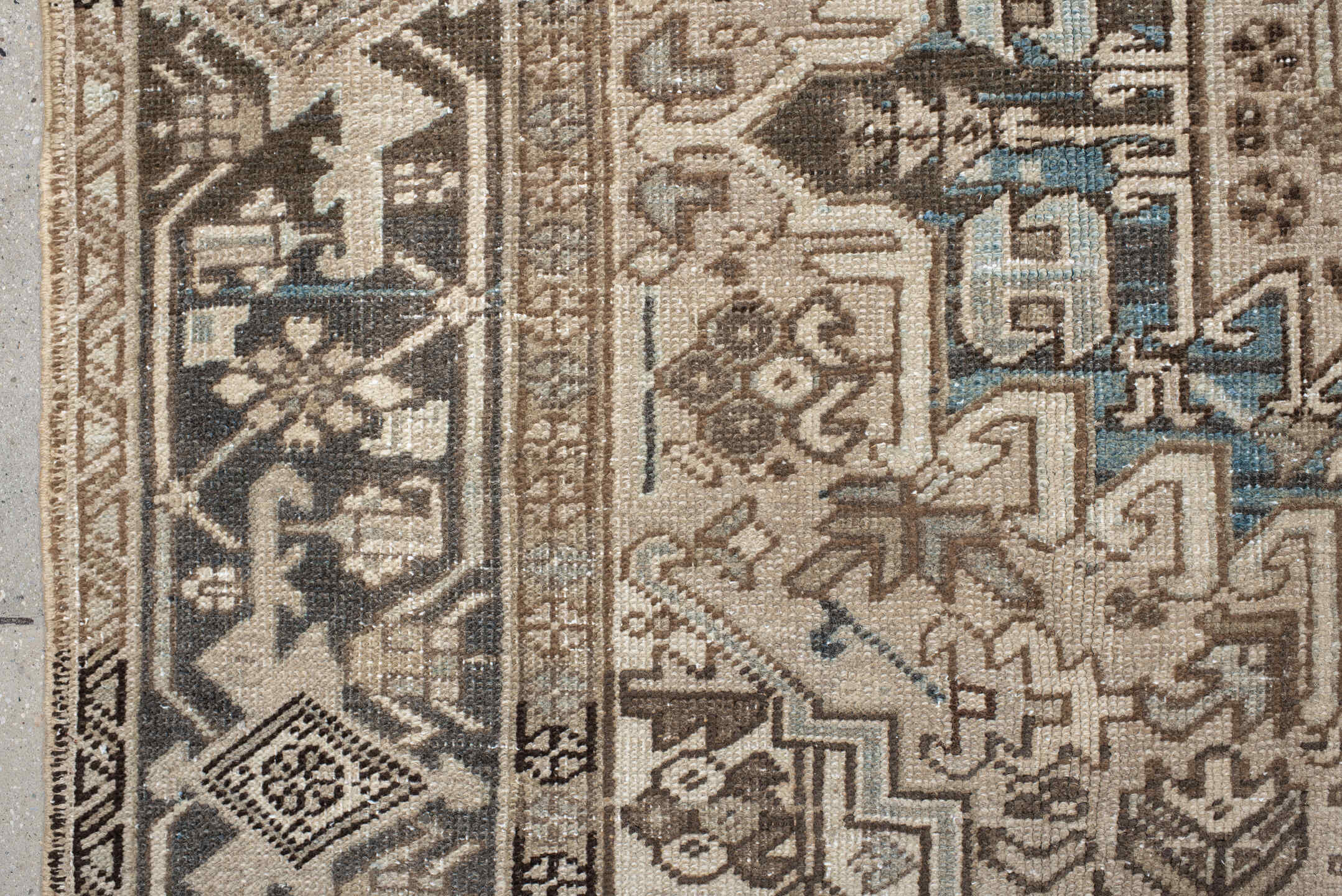 7' x 9' one-of-a-kind handmade antique Heriz rug. Color palette: ivory, taupe, charcoal, beige, sky blue, brown, gray, black