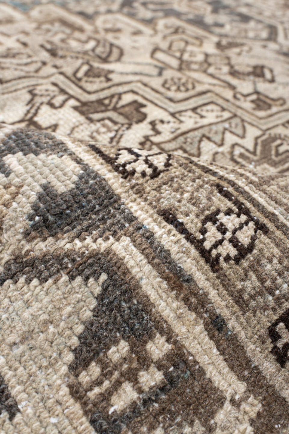 7' x 9' one-of-a-kind handmade antique Heriz rug. Color palette: ivory, taupe, charcoal, beige, sky blue, brown, gray, black