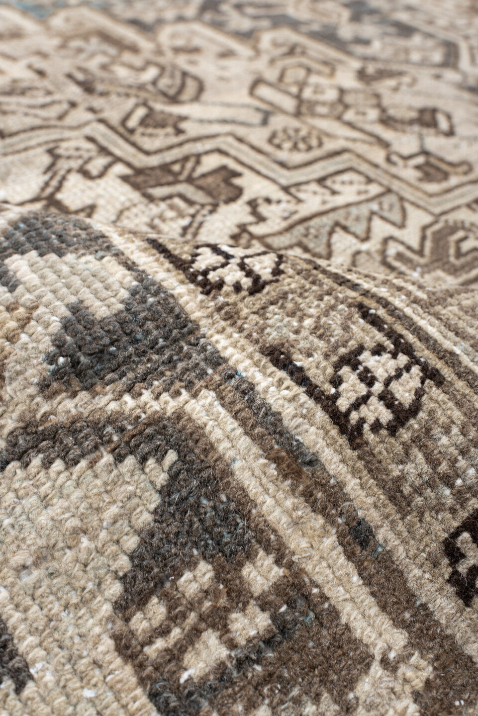 7' x 9' one-of-a-kind handmade antique Heriz rug. Color palette: ivory, taupe, charcoal, beige, sky blue, brown, gray, black