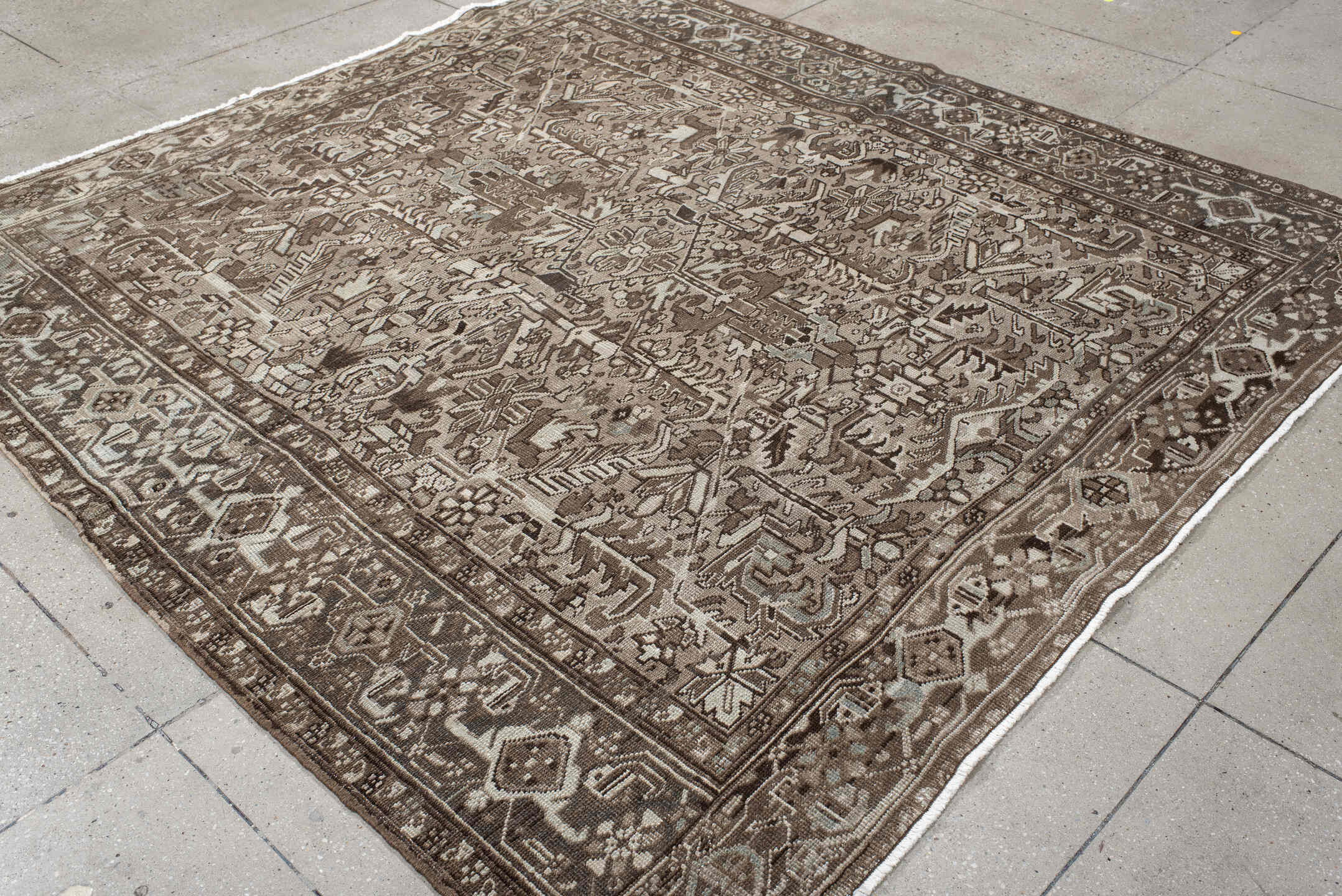 7' x 7' one-of-a-kind handmade antique Heriz rug. Color palette: taupe, brown, ivory, gray, charcoal, beige, black