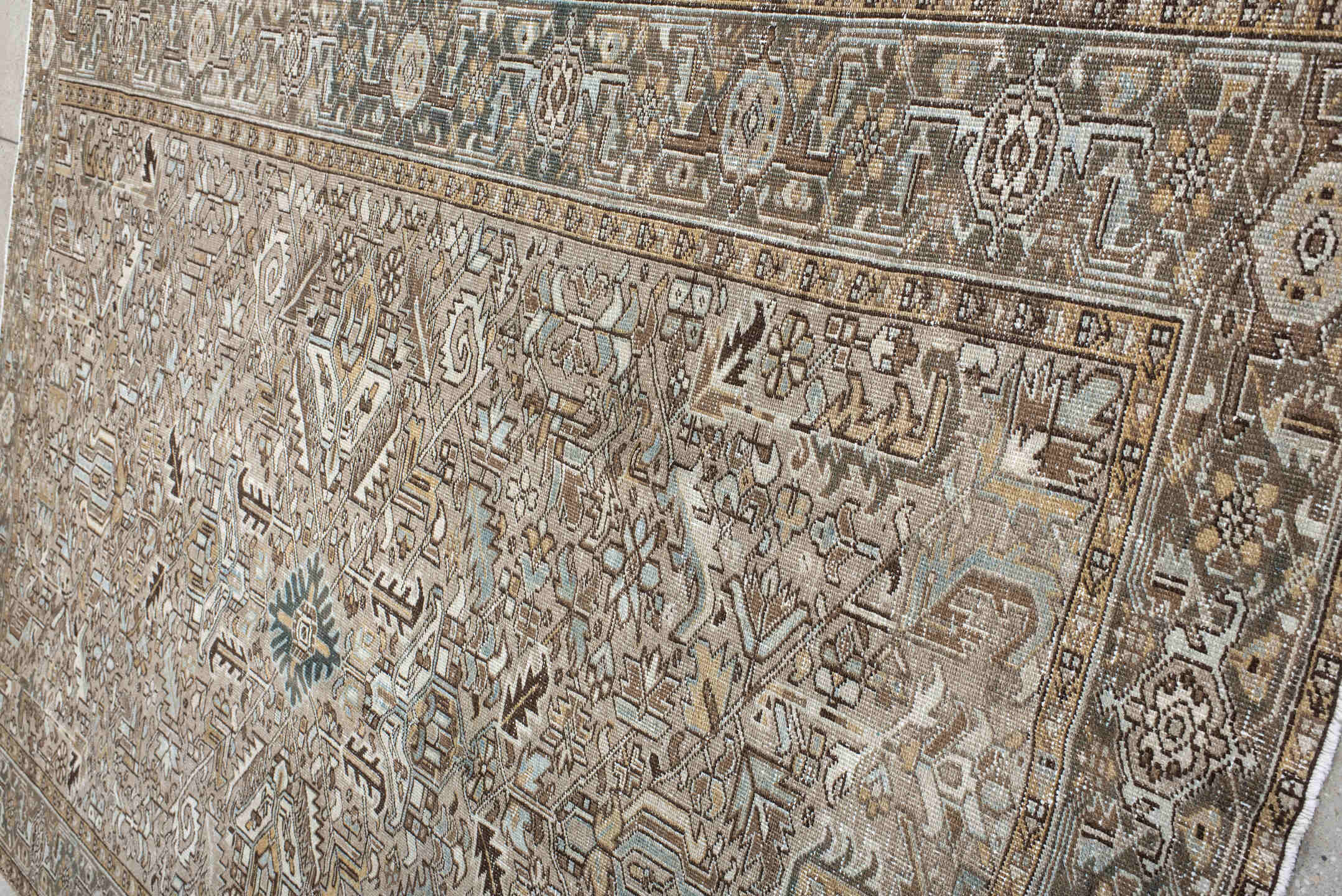 7' x 10' one-of-a-kind handmade antique Heriz large size rug. Color palette: taupe, ivory, slate, camel, brown, pale blue