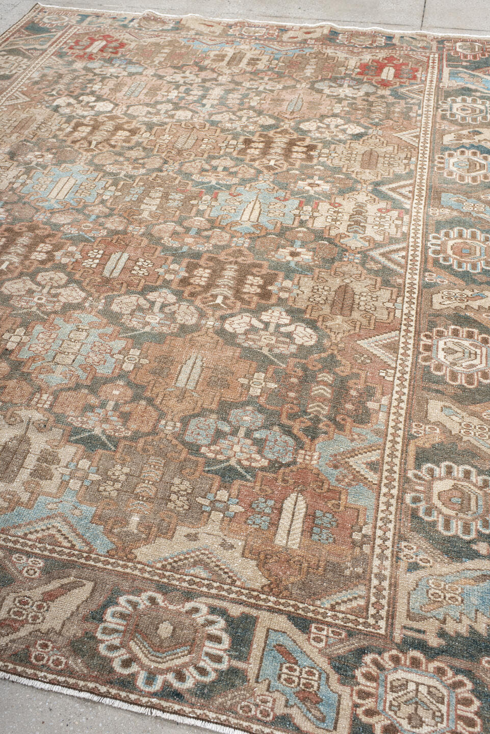 7' x 9' one-of-a-kind handmade vintage Baktiary rug. Color palette: taupe, charcoal, blush, ivory, sky blue, brown, rose
